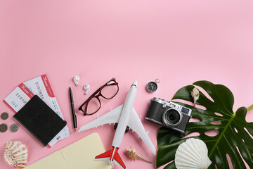 Flat lay composition with toy airplane and travel items on pink background. Space for text