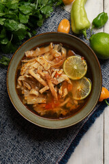 Mexican lime soup with chicken on white background