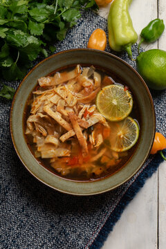 Mexican lime soup with chicken on white background