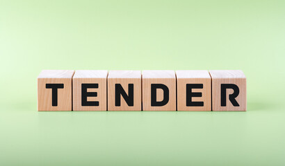 Text TENDER on wooden blocks on a light green background. Business concept.