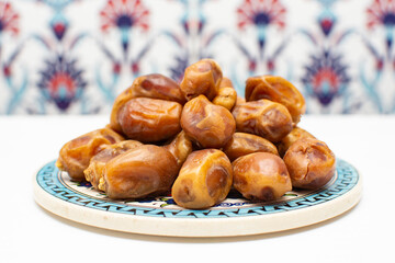 Delicious tasty natural dried dates with eastern background. Especially popular product during the month of Ramadan (aka Ramazan). Diet and proper nutrition. Healthy lifestyle concept.