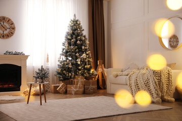 Beautiful living room interior with decorated Christmas tree and modern fireplace