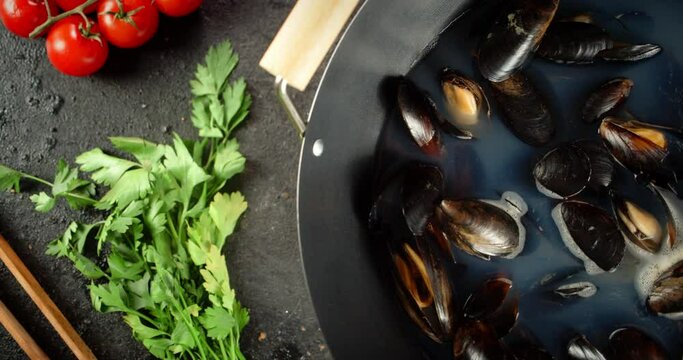 Cooking the mussels in a saucepan. 
