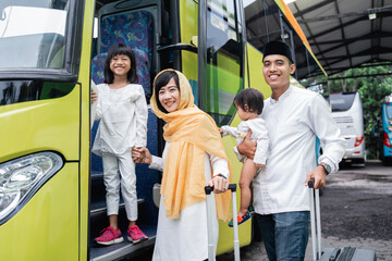 happy asian muslim holiday trip riding a bus together with family