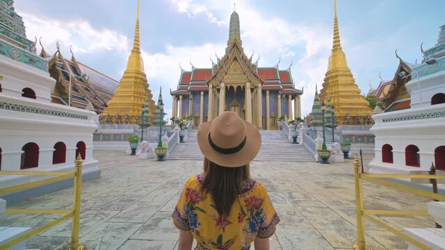 Asian woman visiting Wat Phra Kaew or Emerald buddha temple in Bangkok Thailand