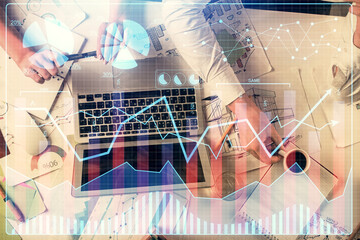 Double exposure of man and woman working together and financial graph hologram. Business concept. Computer background.