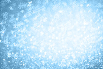 Abstract Christmas and New Year's winter blue background with bokeh snowflakes.