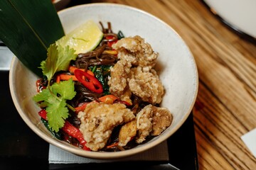noodles with veal and vegetables on a gray table