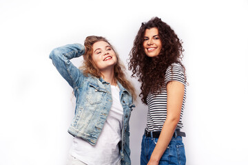 Fototapeta premium young pretty teenage girls friends with blond and brunette curly hairs posing cheerful isolated on white background, lifestyle people concept
