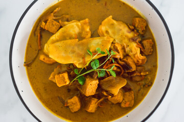 plant-based food,  vegan gyoza and marinated tofu with teriyaki vegetables in curry sauce