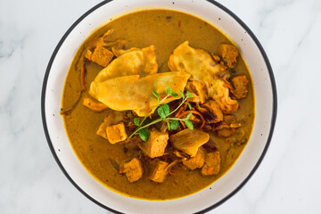 plant-based food,  vegan gyoza and marinated tofu with teriyaki vegetables in curry sauce