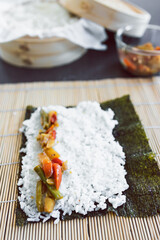 plant-based food, homemade vegan sushi with stir fried vegetable filling getting prepared