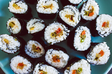 plant-based food, homemade vegan sushi with stir fried vegetable filling