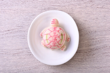 Prosperity Turtle cake on white plate, The Chinese words on the Prosperity Turtle cake means gold...