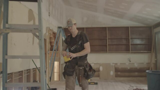 Electrician walks up a ladder to install wires