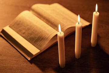 Reading the Bible by candlelight. Religious sermon. Study Of The Holy Scriptures. Christian religion. The concept of religion and faith. Protestantism, Catholicism and Orthodoxy.