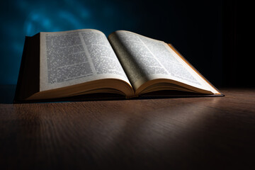 Open Bible on a wooden table. Orthodox religion. An Orthodox person reads the Bible. Word of god. Christian faith. Orthodox faith. The concept of religion and faith.