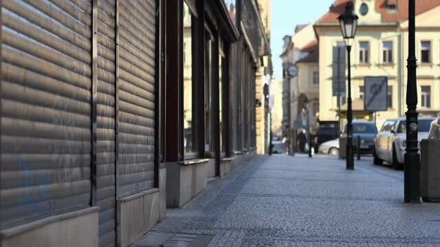 Closed Shops and Empty Sidewalk in Downtown Prague, Czech Republic. Covid-19 Virus Global Pandemic and Lockdown, Slow Motion