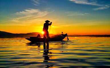 Fisherman of Bangpra Lake in action when fishing, Thailand