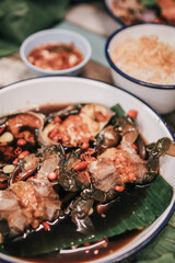 Korean food traditional fresh crab raw soy sauce marinated or Ganjang gejang in Korean name served in white plate on wooden table.