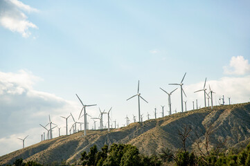 Fototapeta na wymiar Hillside cluster of wind turbines