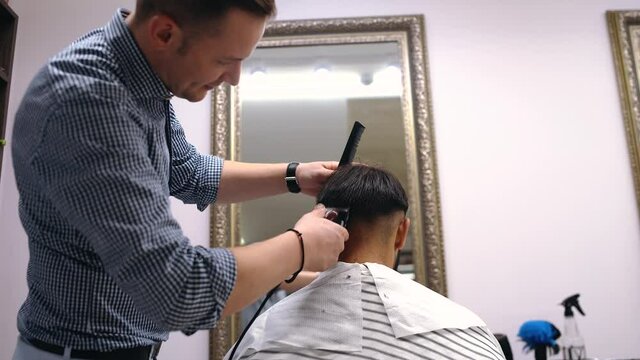 The Professional Barber Discusses With The Client How The Cutter Should Be Executed. Concept Of Reopening Small And Medium Businesses.