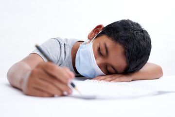 Little boy fell asleep while writing homework, new normal education concept