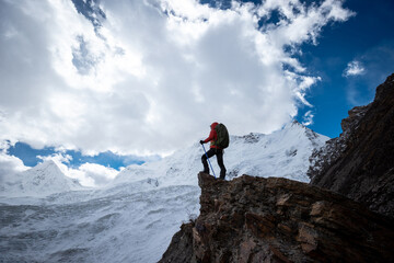 Woman hiker enjoy the view on winter mountain top cliff edge