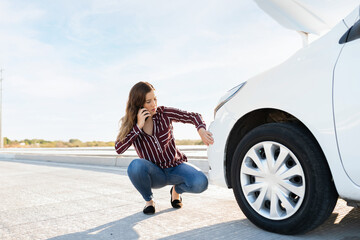 Young woman calling to get road assistance