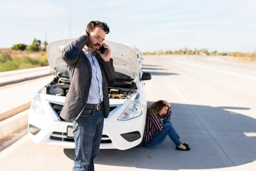 Angry couple stranded on the highway because of a dead car