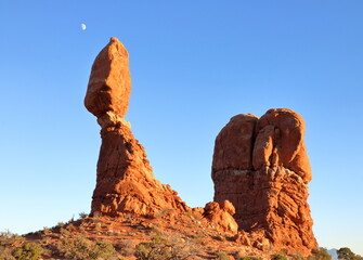 Fototapeta na wymiar Balanced Rock formation with moon in background, Arches National Park