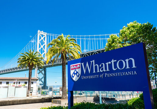 Wharton University Of Pennsylvania Sign Near School Campus With San Francisco Oakland Bay Bridge In Background - San Francisco, California, USA - 2019