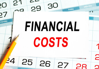FINANCIAL COSTS. Abstract calendar close up background. Business concept written on notepad with space.