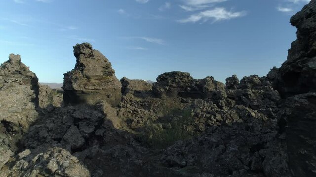 Rising through lava rock formations spires Dimmu Borgir Iceland aerial