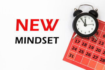 NEW MINDSET Abstract calendar and Watch. Business concept written on notepad