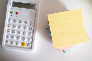 post it note pad and white minimalist calculator