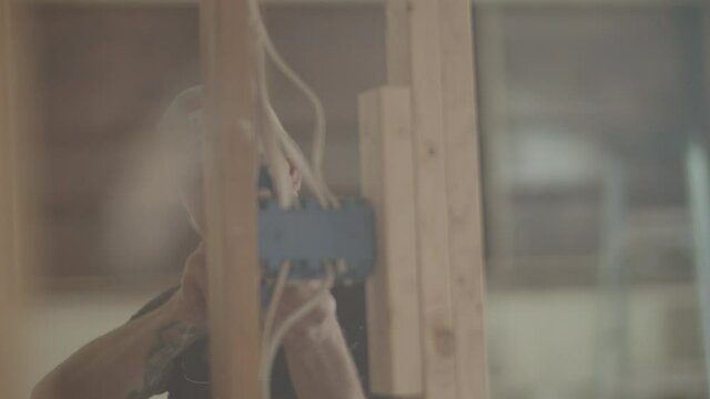 Electrician is wiring a home