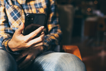 man work using cell phone hand holding mobile texting message contact us.chatting,search internet information in office.technology device communication connecting