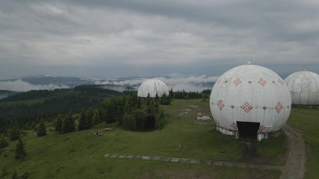Hovering over abandoned USSR radar station as clouds pass by overhead