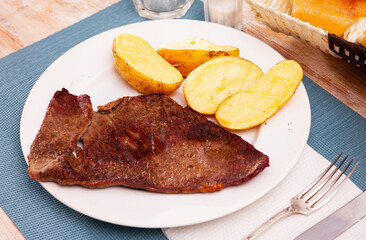 Well done beef entrecote with garnish of baked potato in skins. Delicious and healthy dinner