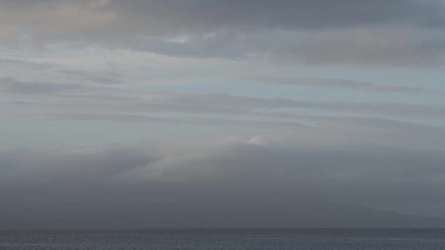 Time lapse footage of moving clouds over fjord in Norway