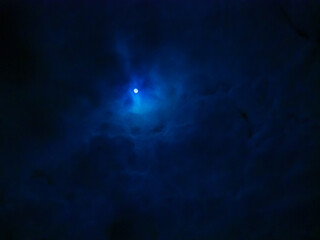 Mystic Moon Hangs in Swirl of Clouds in Night Darkness