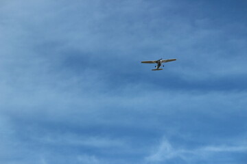 Fototapeta na wymiar Airplane In The Blue Sky With Clouds