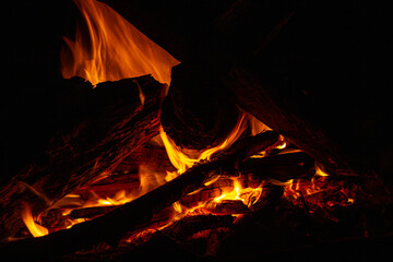 Campfire close up at night with black background. Fire heat adventure camping concept