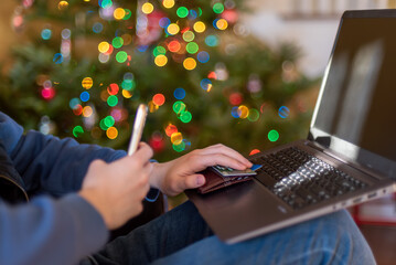 Young man shopping online for holiday gifts