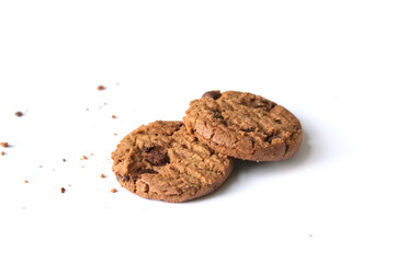 Chocolate chip cookies with crumbs isolated on white background