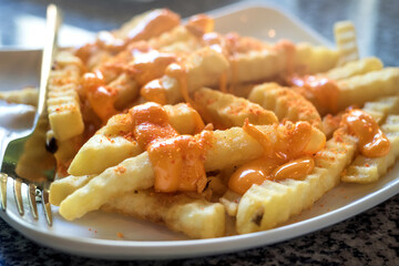 Close up of Thick and crunchy potatoes sprinkled with sauce
