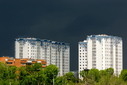 Dramatic low stormy dark sky over buildings.