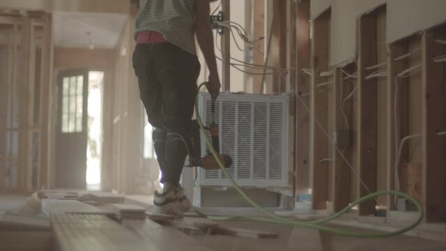 Construction worker is on his knees working hard