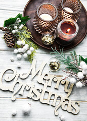 Christmas composition with candles and fir branches.